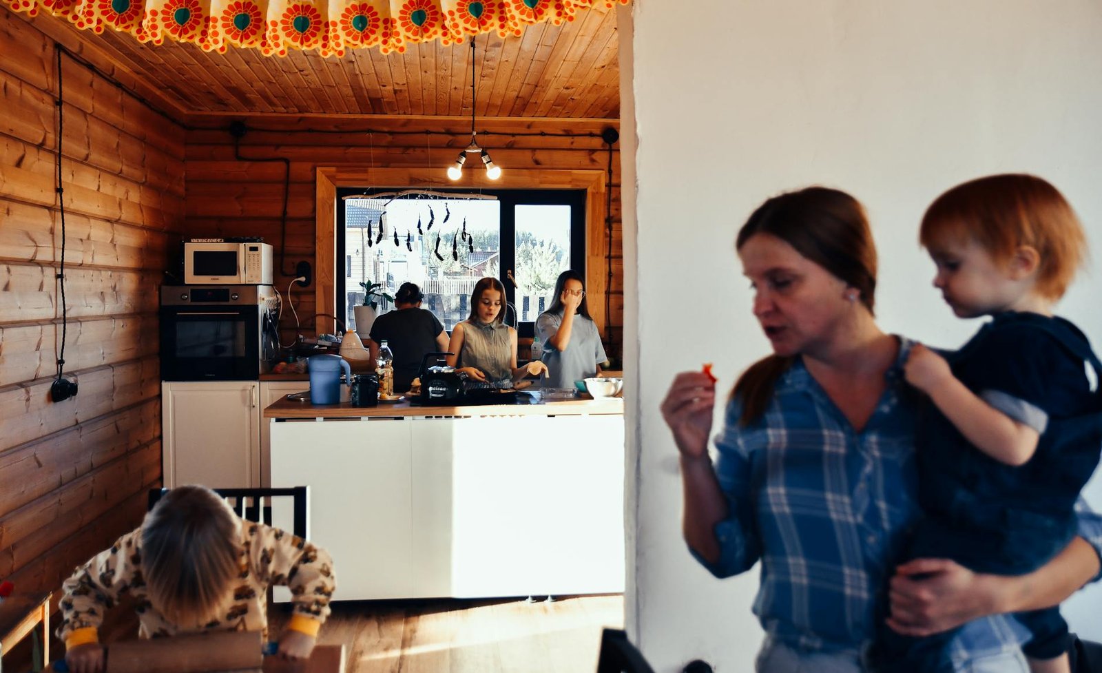 people eating and cooking in wooden house