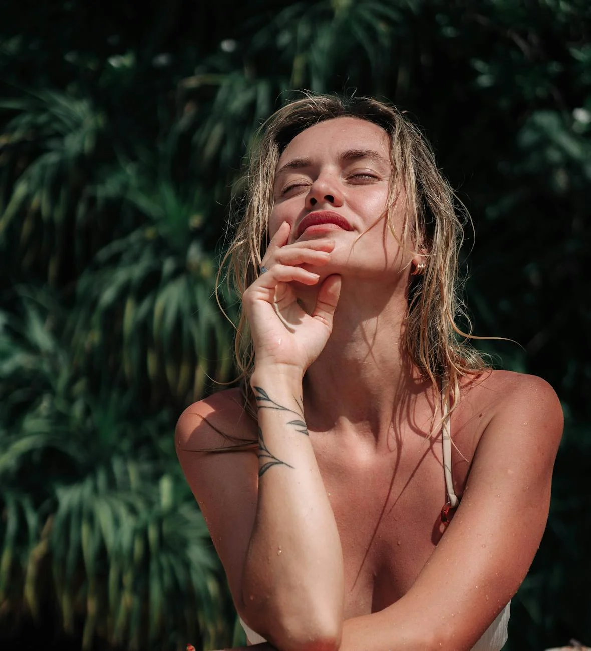 Blonde sunbathing with closed eyes