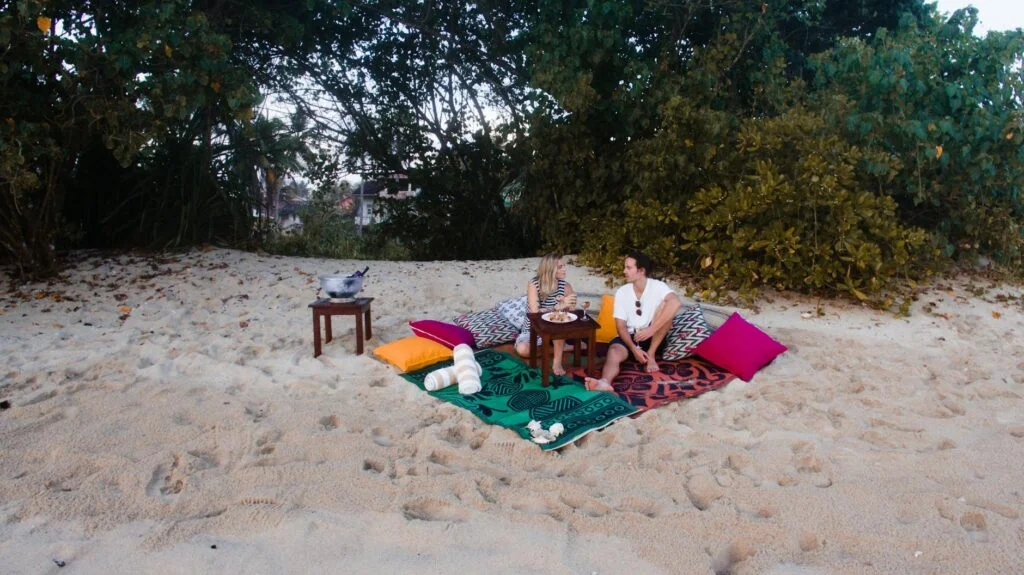 A couple having a picnic on the beach