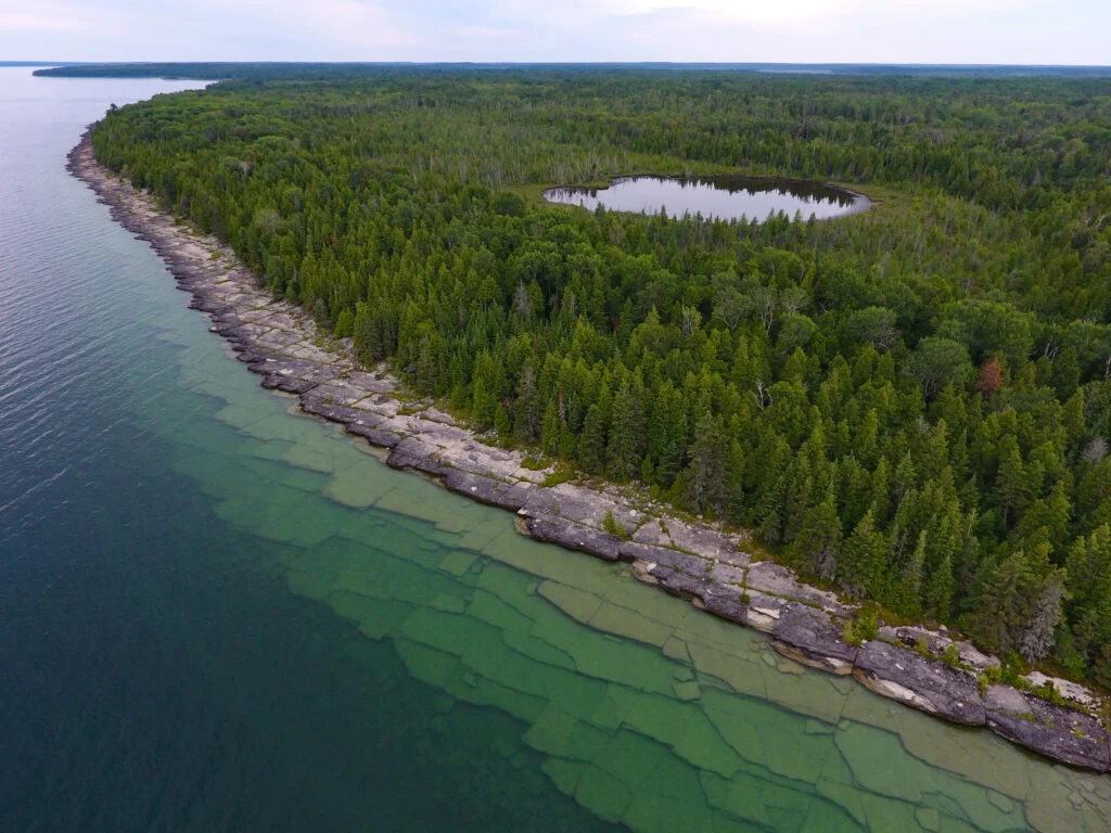 Shelves of a limestone bedrock shoreline appear like steps into lake huron