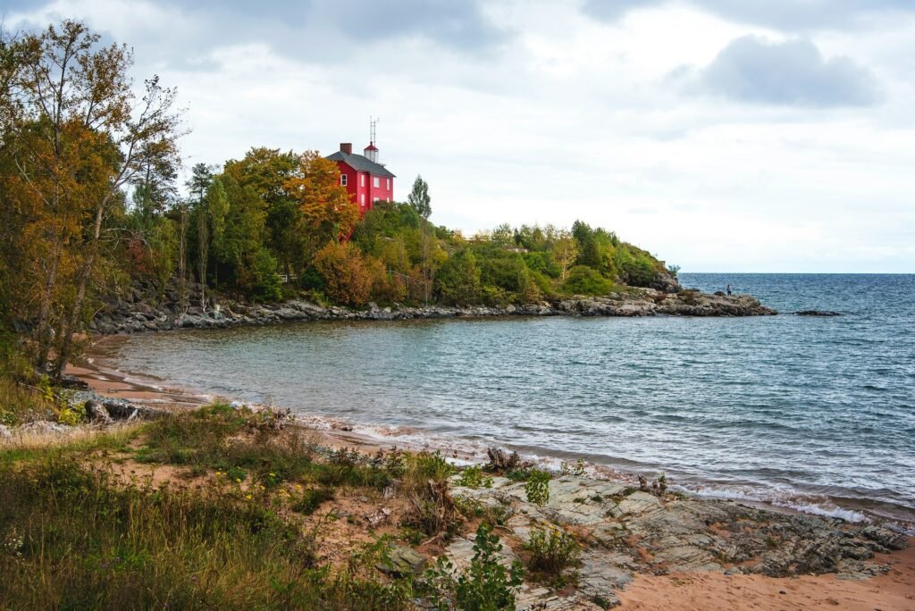 Red house by the serene shore.