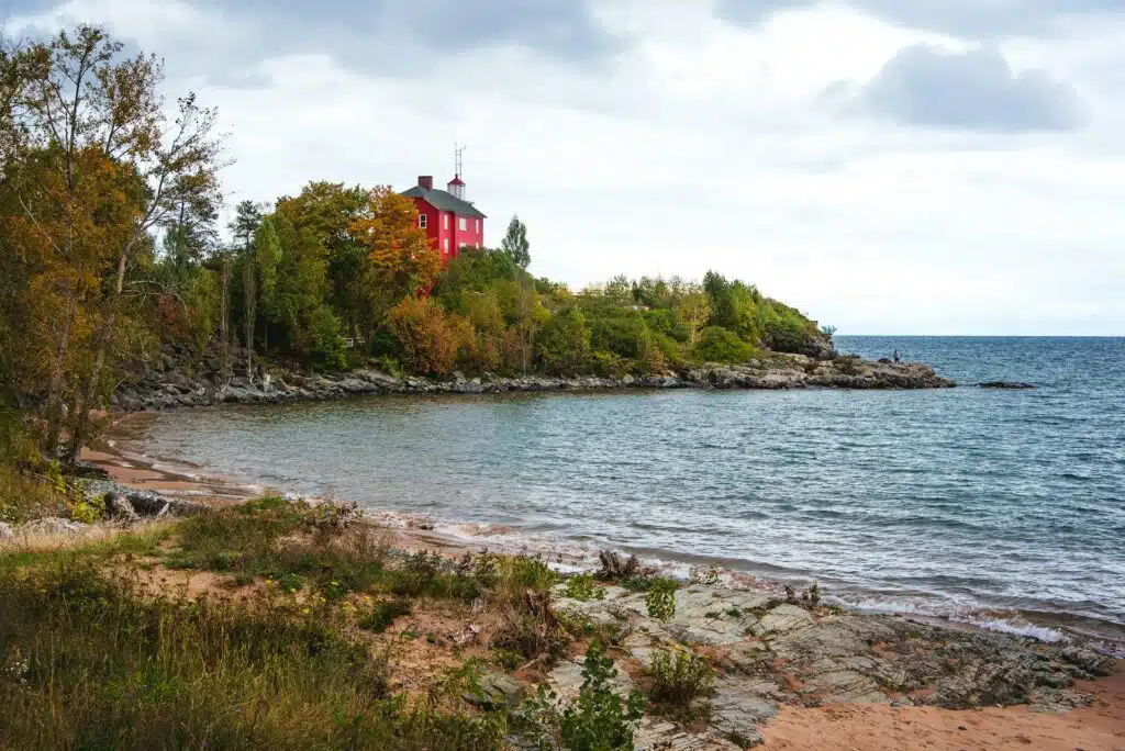 Red house by the serene shore.