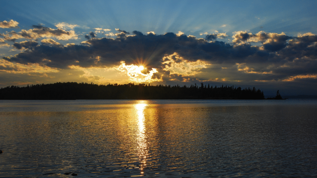 Sunset over calm lake waters