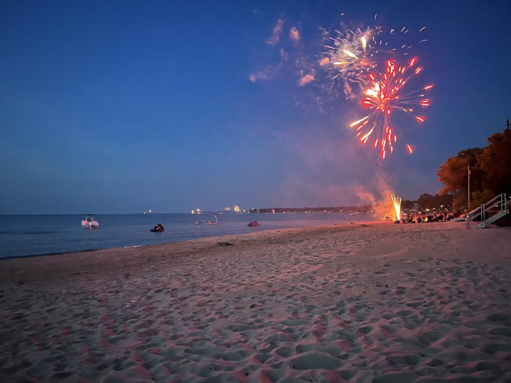 Fireworks over beach at dusk