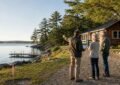 Three people discussing a lakeside cottage.
