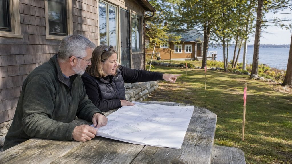 Couple discussing plans by the water
